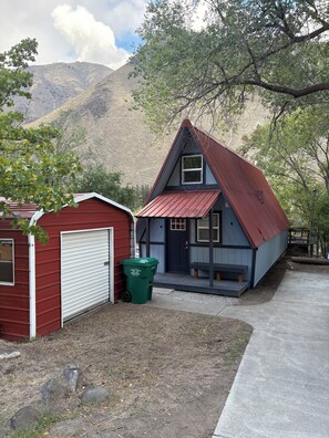 A two-story house with a red garage and a blue exterior.
