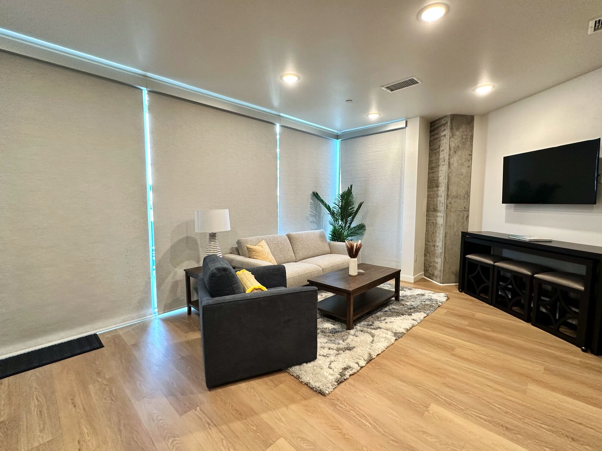A modern living room with a sofa, coffee table, and TV.