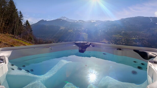 A hot tub with a mountain view.