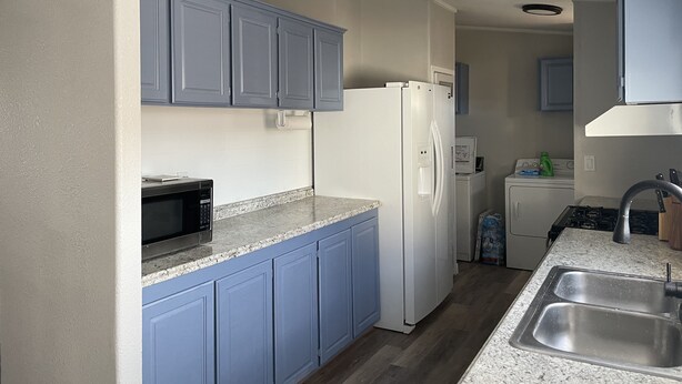 A modern kitchen with blue cabinets, a white refrigerator, a microwave, a sink, and a stove. - SEVEN National Parks w/in 2 hrs. Come EXPLORE. Come PLAY. Come RELAX...REPEAT!!! (Kanab)