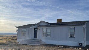 A single-story house with a front porch, a chimney, and a satellite dish. - SEVEN National Parks w/in 2 hrs. Come EXPLORE. Come PLAY. Come RELAX...REPEAT!!! (Kanab)