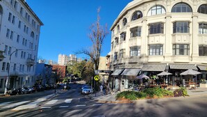 A corner building with a pet supplies store and outdoor seating.