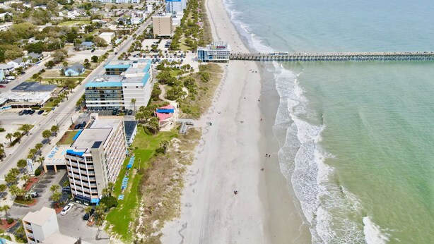 An aerial view of a coastal city with a beach, buildings, and a pier. - Sea View Home 6 bed 3bedroom-garage near boardwalk (Myrtle Beach)