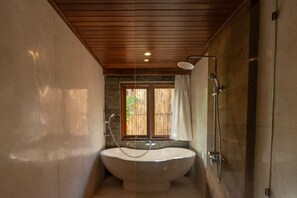 Separate bathtub and shower, towels, soap, shampoo