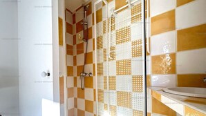 A bathroom with a shower, a sink, and a toilet.