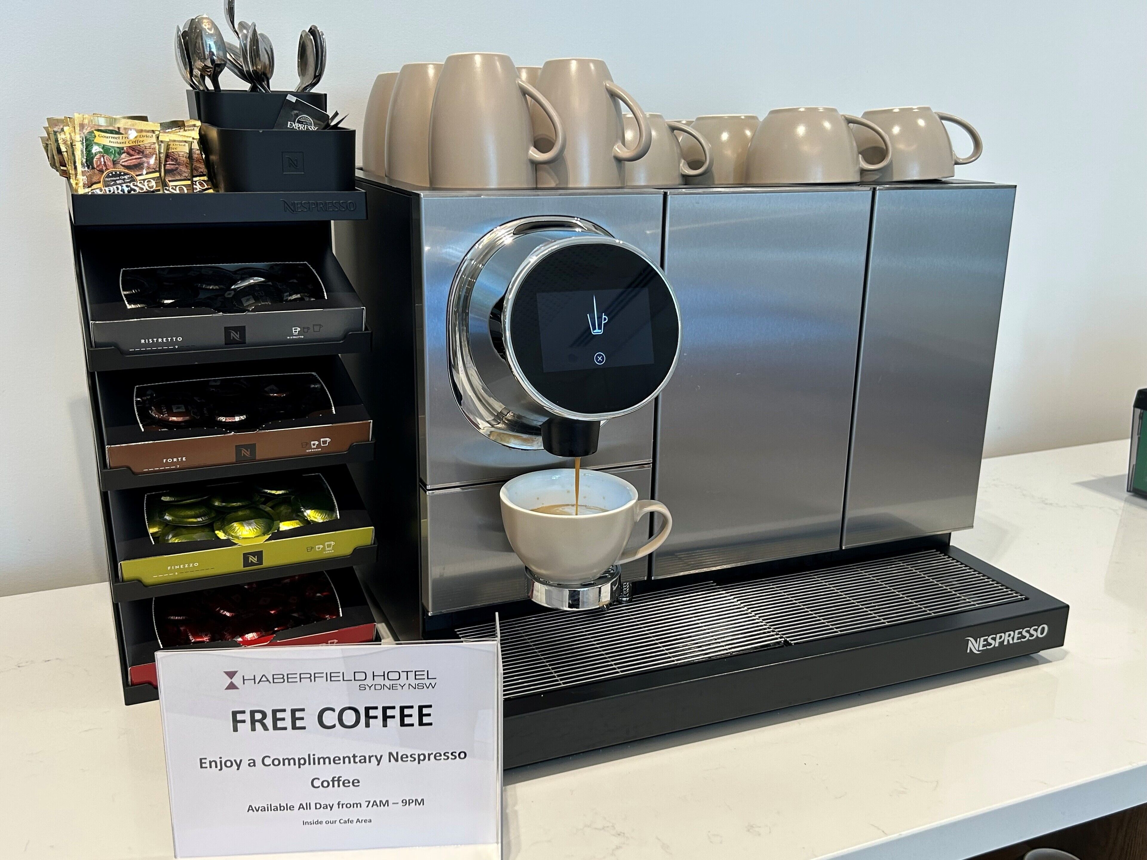 A Nespresso coffee machine with a sign offering free coffee.