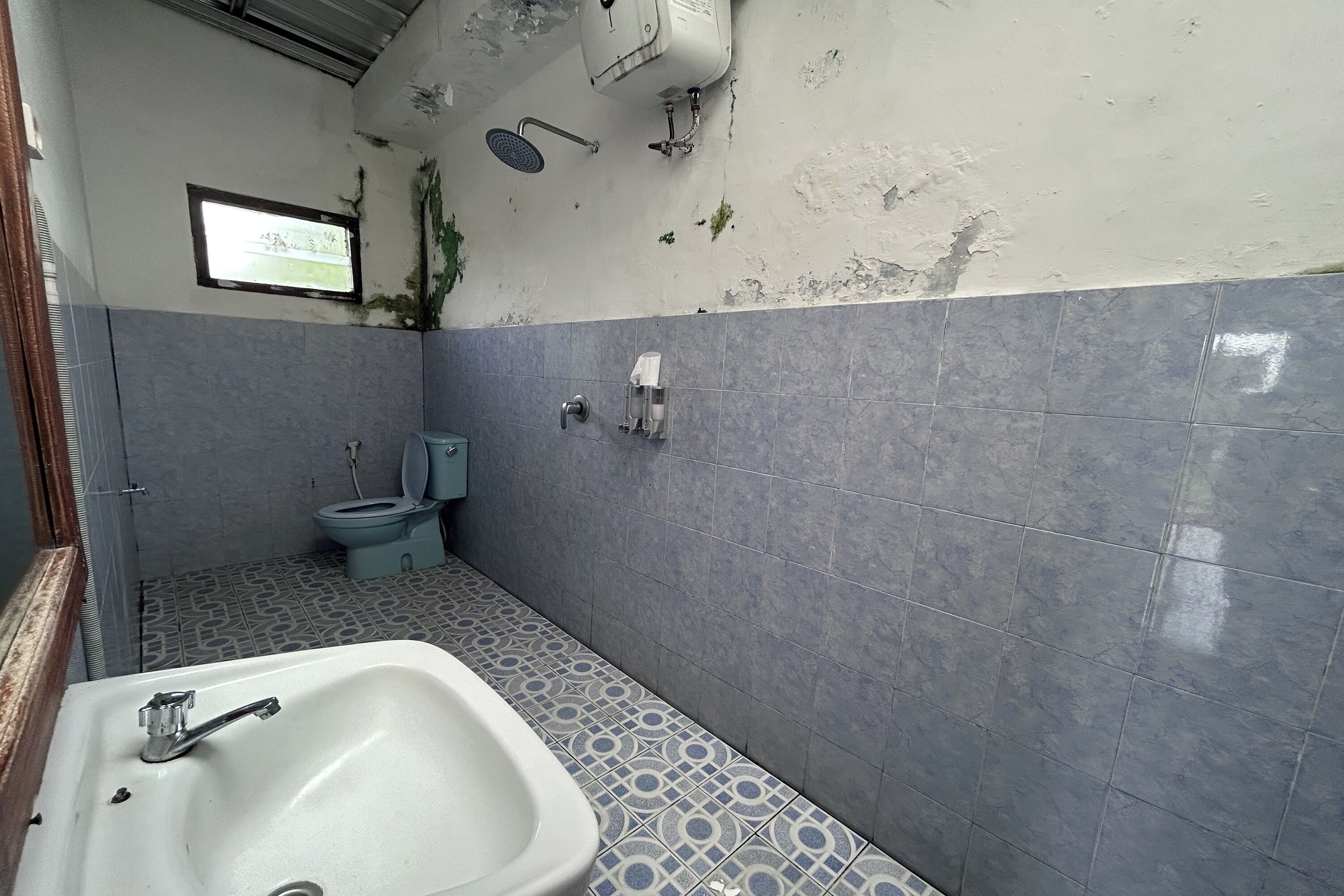 A bathroom with a sink, toilet, and shower.