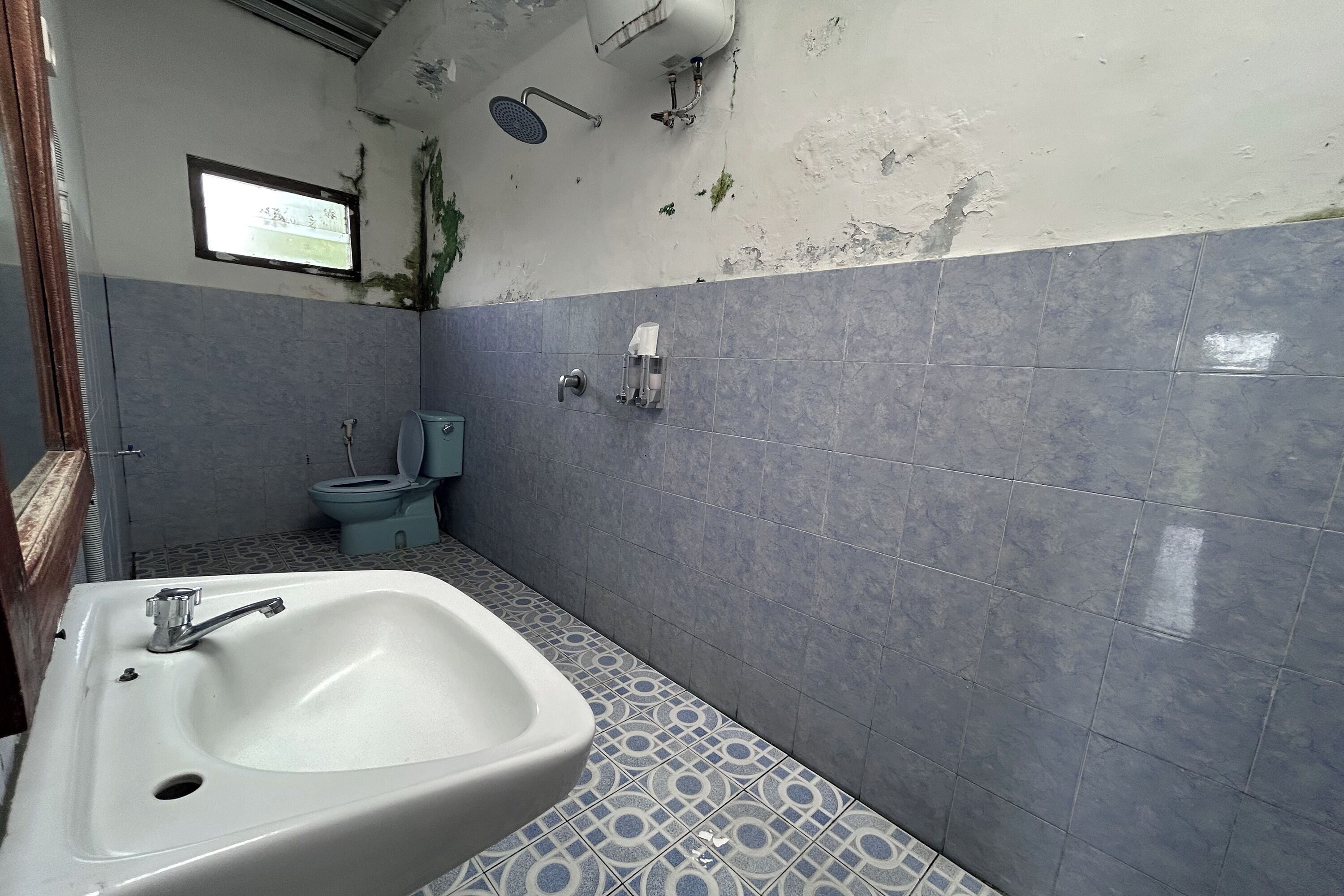 A bathroom with a sink, toilet, and shower.