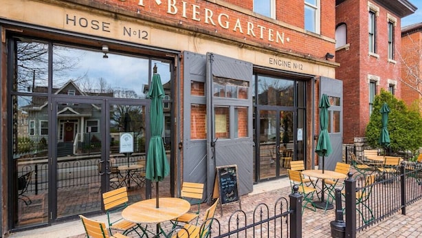 A brick building with a sign reading "GEMUT BIERGARTEN" and "HOSE NO 12". - Central Loft with Pool Table! Pet-friendly Haven! (Columbus)