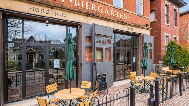 A brick building with a sign reading "GEMUT BIERGARTEN" and "HOSE NO 12". - Modern Apartment with Pool Table! Pet-friendly! (Columbus)