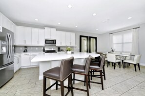 Fridge, oven, stovetop, dishwasher - Stylish Home with Private Pool, Themed and Game Room with Waterpark & Resort Access near Disney at. (Kissimmee)