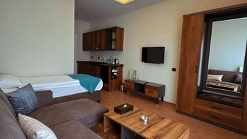Junior Room, 2 Bedrooms | Living area | 32-inch Smart TV with cable channels