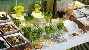 A buffet table with various food items and drinks.