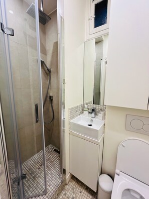 Een douche, een haardroger, handdoeken, toiletpapier