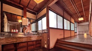A traditional Japanese-style room with a wooden interior, a sink, and a mirror.