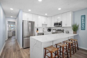 Oven, stovetop, dining tables - Hammerhead Beach Condo (Ocean City)