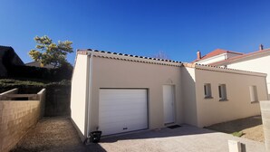 A small, single-story building with a white garage door, a small door, and a window. - Nouvelle Villa Provençale Calme, Proche du Centre (Montélimar)