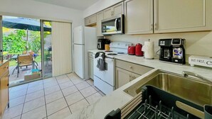 A compact kitchen with a microwave, stove, and coffee maker. - Near Fort Myers Beach • 2BR • 2BA • Grill (Fort Myers Beach)