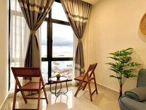 Deluxe Condo, Sea View | Living area | LED TV