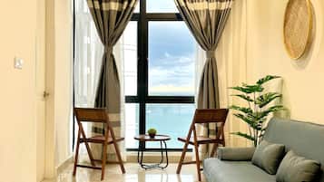 Deluxe Condo, Sea View | 1 bedroom, desk, laptop workspace, iron/ironing board