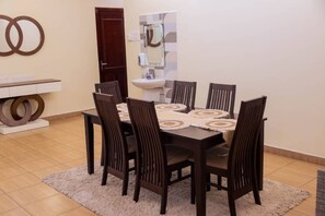 Dine in comfort with a stylish table and six chairs, set against a beautifully tiled floor.