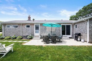 A house with a patio, a grill, and a covered outdoor seating area. - Water Views, Access to Grand Cove! (Dennis)