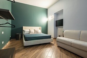 Habitación cuádruple Deluxe | Sábanas italianas Frette, ropa de cama de alta calidad, minibar