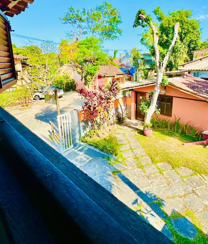 A residential area with houses, a paved pathway, and a small gate.