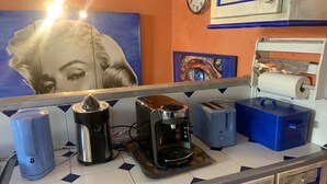 A kitchen counter with a coffee maker, toaster, and blue storage box. - Appartement de Luxe au Cœur D'aix-en-provence (Aix-en-Provence)