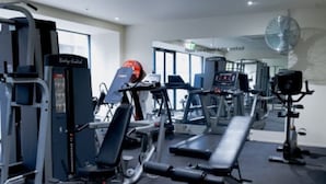 A gym with various exercise machines, including treadmills and weightlifting equipment. - St Kilda Rd Gem | Prime Spot (Melbourne)