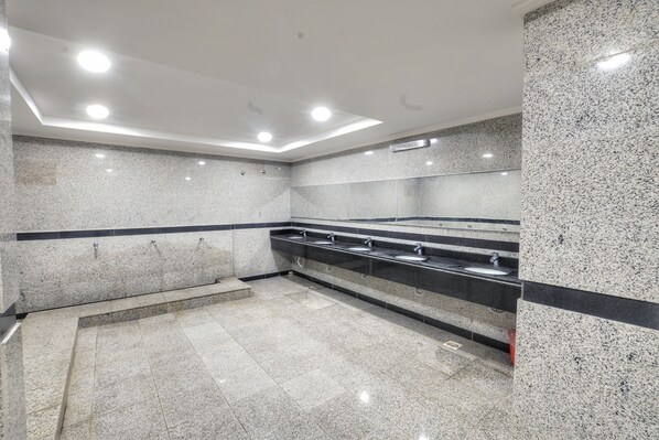 A modern restroom with granite countertops, multiple sinks, and recessed ceiling lighting. - Zouk AlKhayal Hotel (Makkah)