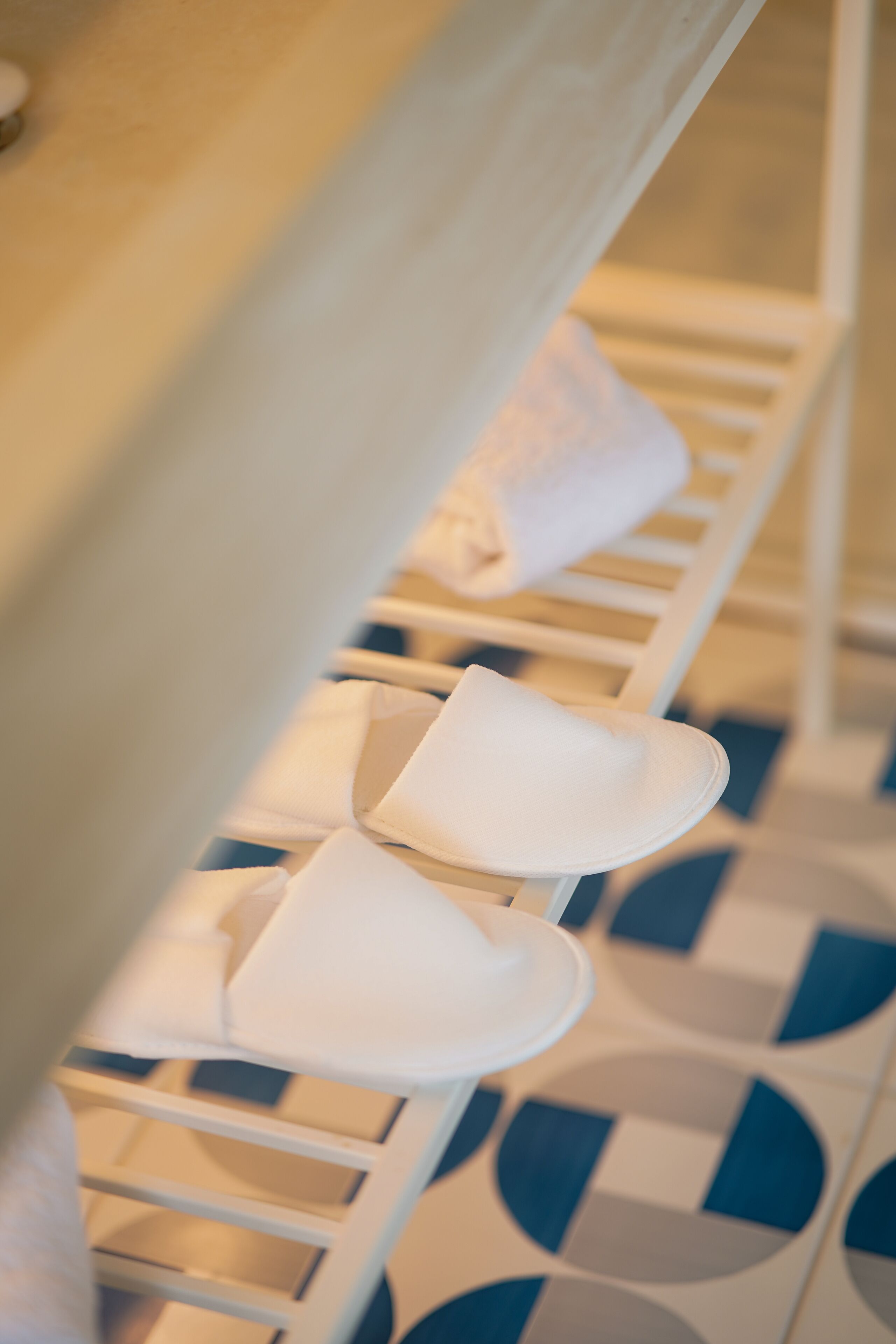 A row of white towels neatly arranged on a rack.