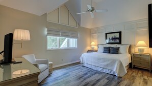 A bedroom with a large bed, a ceiling fan, a desk with a lamp, and a window with blinds. - 2 Duck Hawk - Sea Pines just a Short Walk to the Beach & Private Pool (Hilton Head Island)