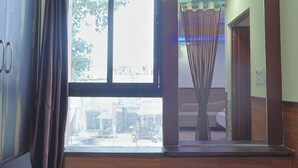 A room with a large window, a wardrobe, and a curtain. - TRPOTEL SUBMANGAL (Gwalior)