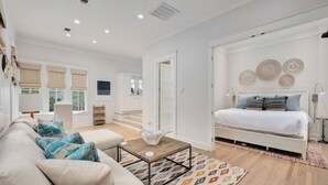 A modern bedroom with a bed, a sofa, and a coffee table. - Seabbatical at WaterColor|Private Community Beach Access|On Western Lake (WaterColor)