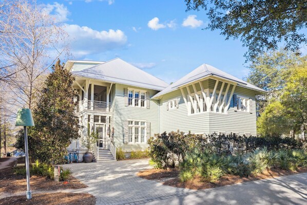 A two-story house with a front porch, a covered staircase, and a well-maintained garden. - Seabbatical at WaterColor|Private Community Beach Access|On Western Lake (WaterColor)