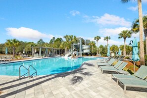A swimming pool with lounge chairs and umbrellas, surrounded by palm trees. - Seabbatical at WaterColor|Private Community Beach Access|On Western Lake (WaterColor)