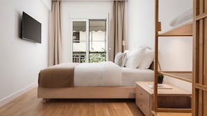 A modern bedroom with a bed, bedside table, and a TV mounted on the wall. - Athenian Hillside Residence (Athens)