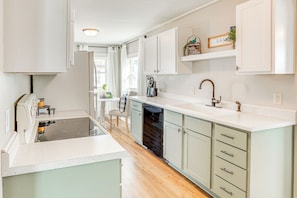A modern kitchen with white cabinets, a dishwasher, and a countertop. - Pet-friendly Watertown Home ~ 1 Mi to Downtown! (Watertown)