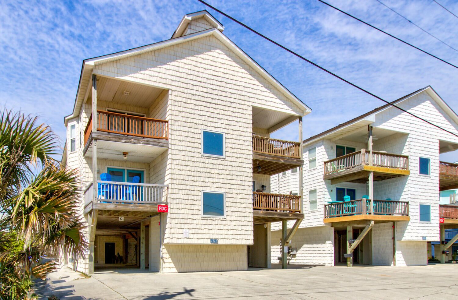 A multi-story building with balconies, a garage, and a visible 'FDC' sign.