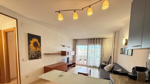A modern apartment with a dining area, kitchenette, and a balcony with a view. - Agi Port Canigo 130 Apartamento for rent in Roses Girona. (Roses)