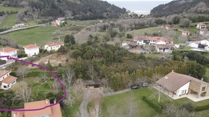 An aerial view of a residential area with houses, roads, and greenery. - Short description of the property (San Juan de Duz)