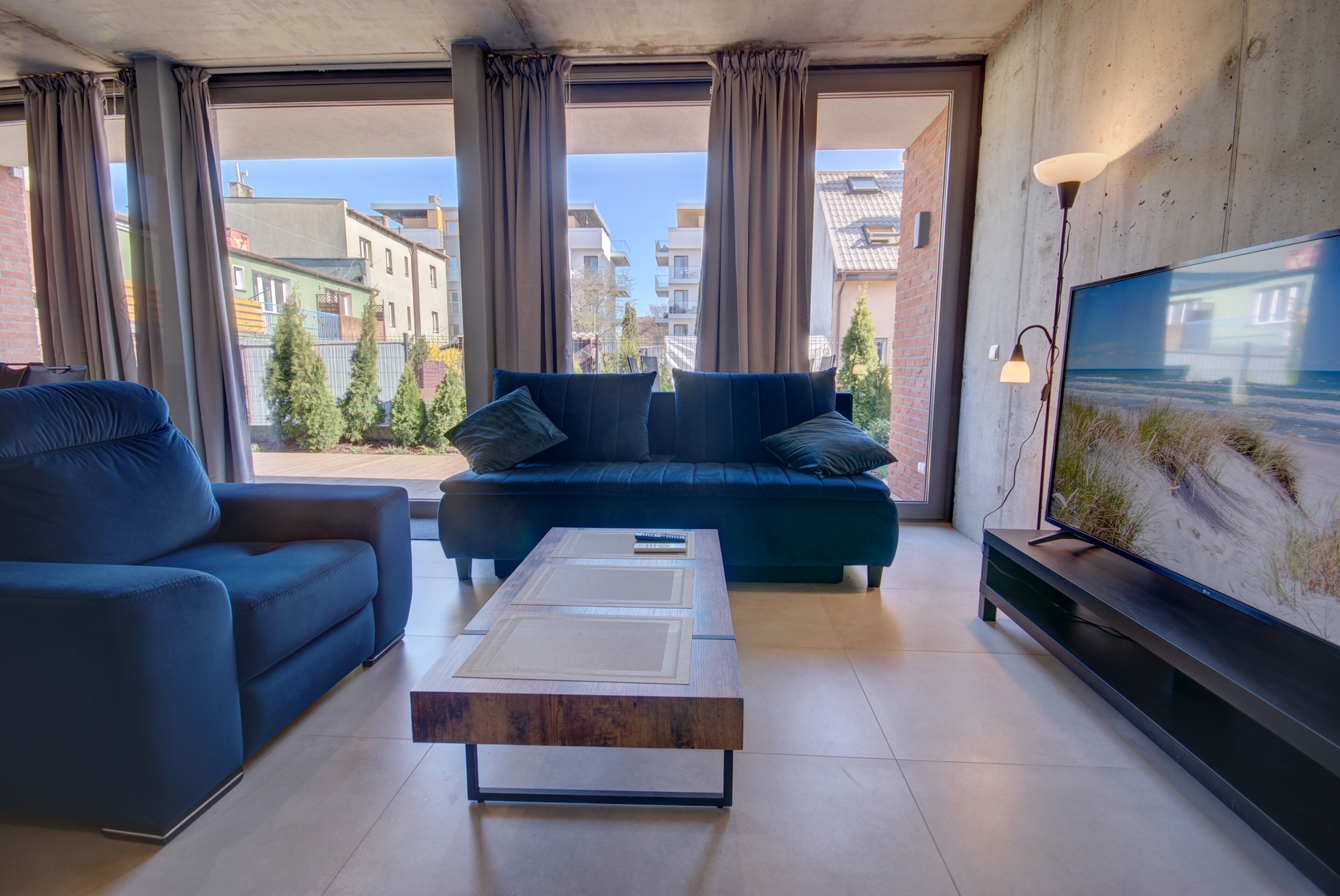 A modern living room with a sofa, a coffee table, and a TV.
