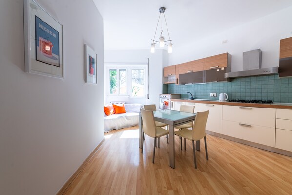 A modern kitchen with wooden cabinets, a gas stove, and a tiled backsplash.