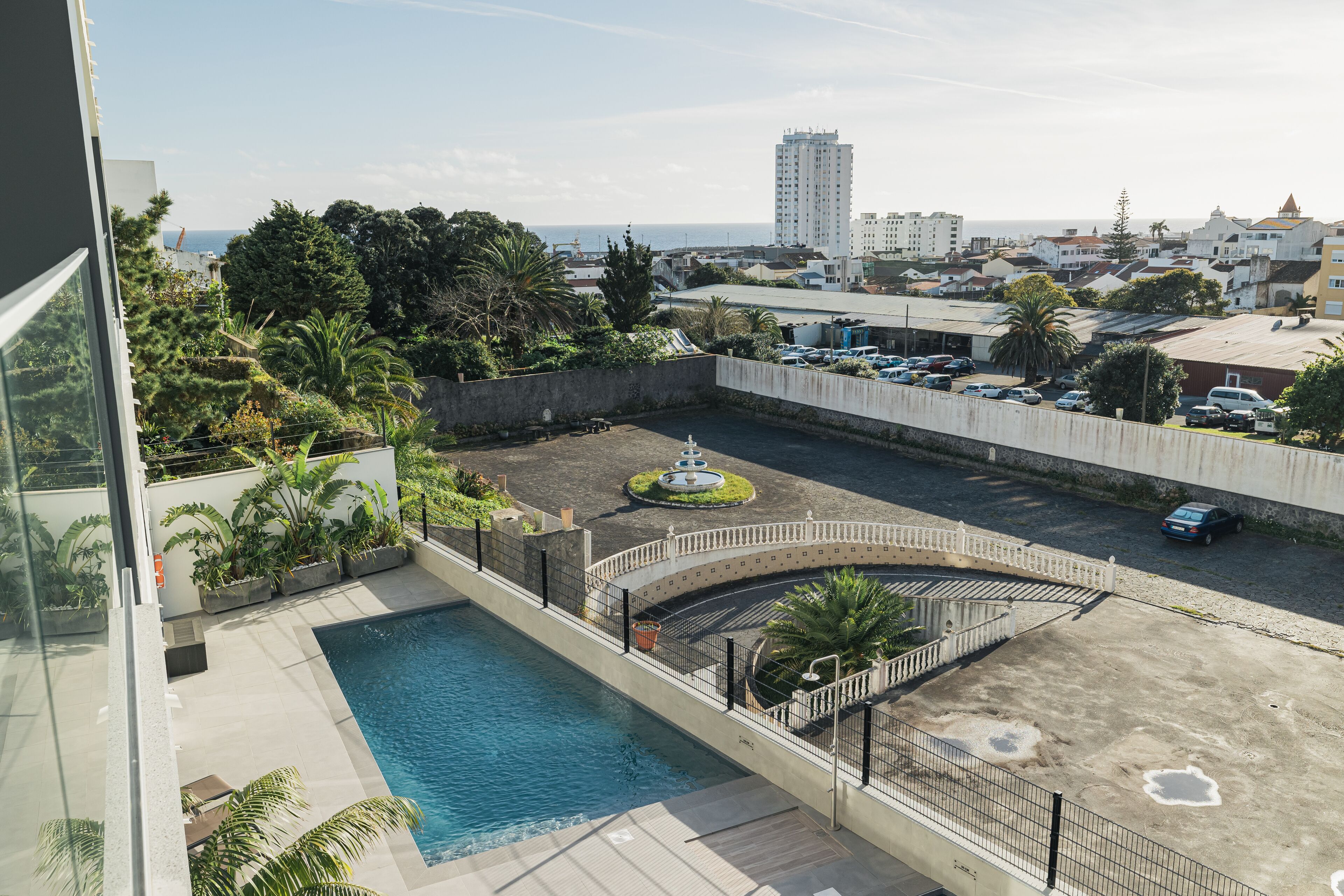 A rooftop pool with a view of the city and ocean.