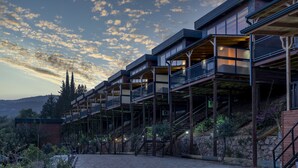 A modern hotel with multiple balconies, outdoor staircases, and a stone pathway. - La Veranda Villas (Kumluca)