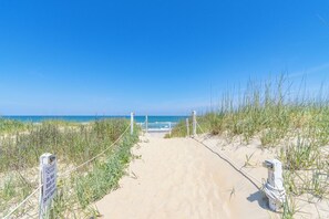 A sandy beach path leading to the ocean with a sign warning against walking on the dunes. - Oceanfront condo in Nags Head w/ community pool just steps to the sand! (South Nags Head)