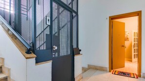 A staircase with a metal gate leading to a room.