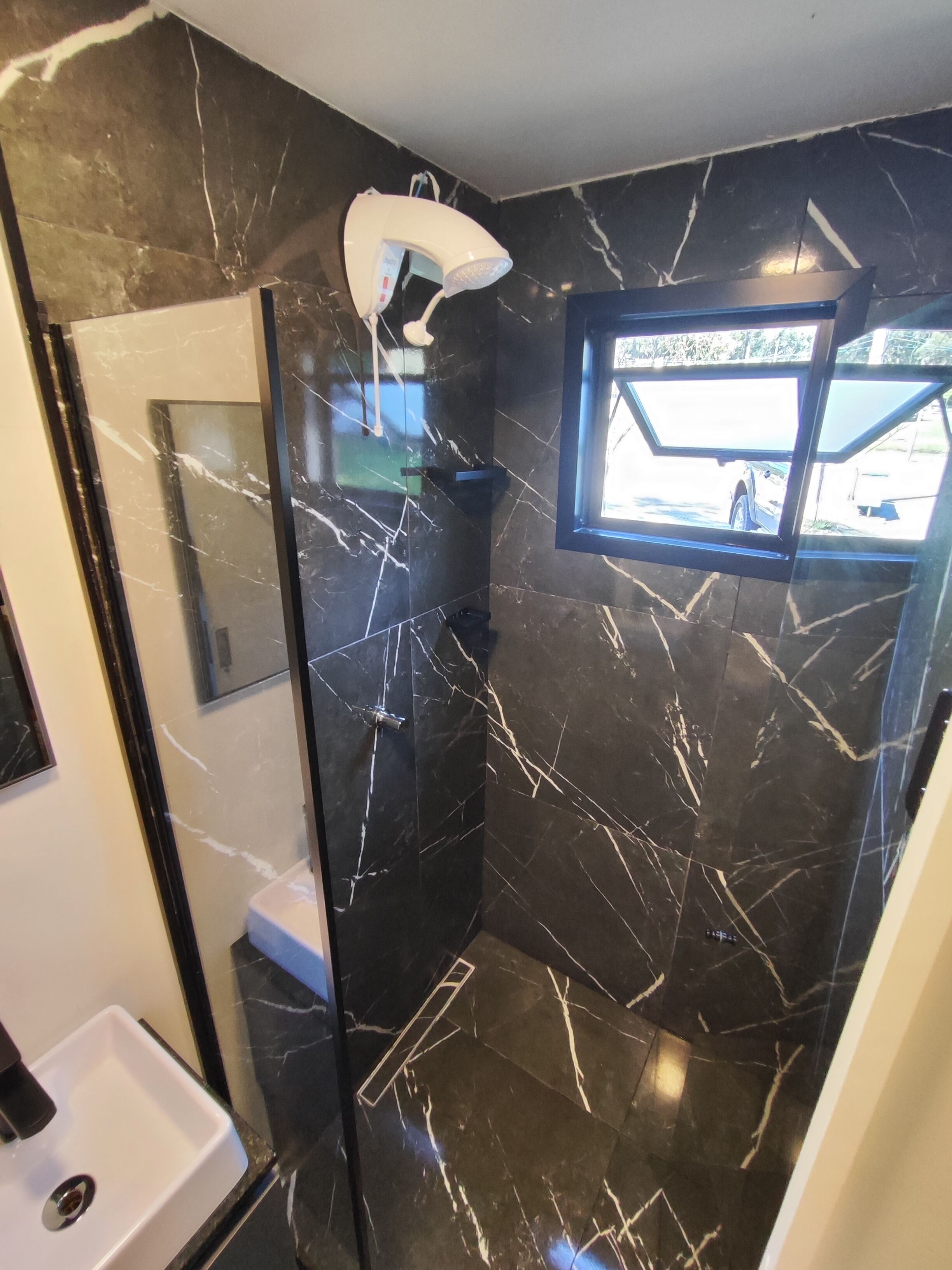Shower, pengering rambut, handuk, dan tisu toilet