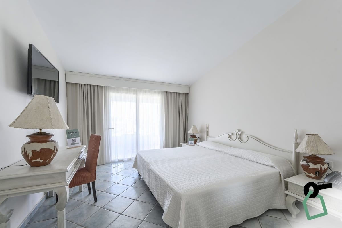 Comfort Double Room, Patio, Sea View | Minibar, in-room safe, desk, laptop workspace